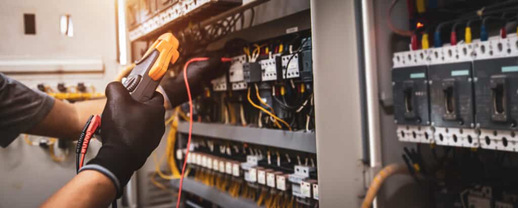 Electrician use electrical measuring tool meter checking circuit breaker power electricity switchboard cabinet for service maintenance and electric cable wiring check for safety concepts.